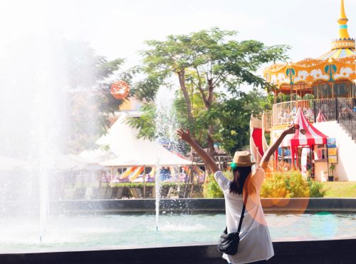 Young woman in happiness feeling with amusement park ride background